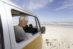 Insurance for Motorhomes - retired woman looking out of camper window