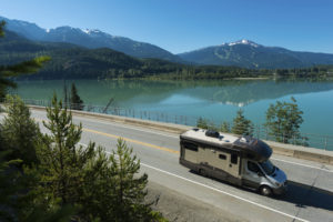 RV driving along a spectacular section of Highway 99 past Green Lake in Whistler, BC