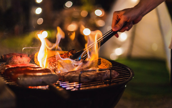 person grilling at a camping site