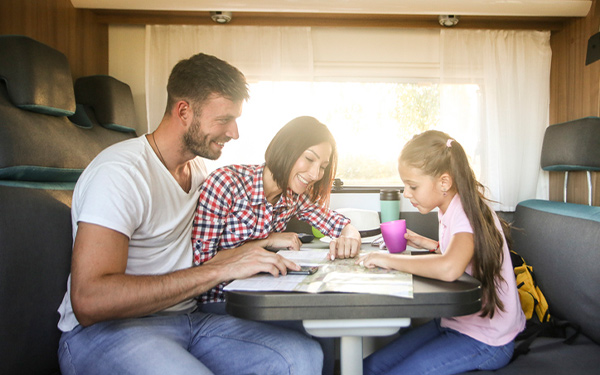 parents roadschooling their child in an RV