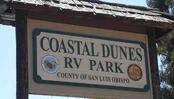 Welcome sign that reads Coastal Dunes RV Park