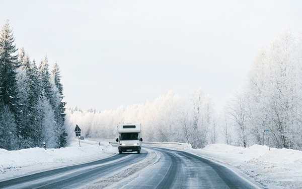 An RV on a road during winter