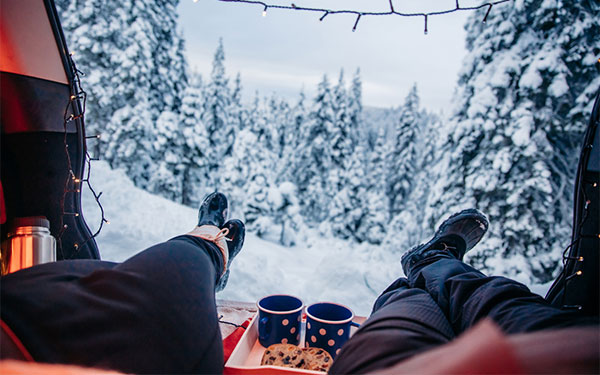 two people sitting in their car at a national park in winter