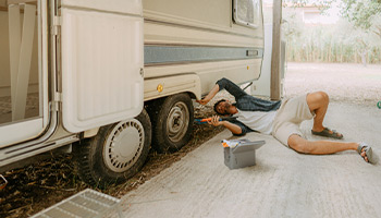 a person working on their RV tires and performing basic maintenance