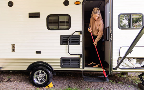 A woman getting ready to store her RV by cleaning inside