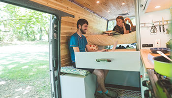 Image of a couple inside of an RV. Showing it is possible to rent different types of RVs with Outdoorsy. 