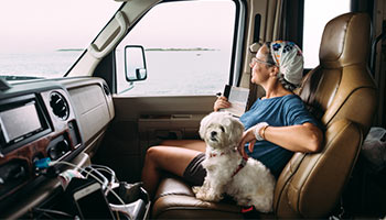 Image of the person in an RV with their pet. Showing it is possible to rent pet friendly rvs with RVshare. 