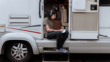 a teenager completing homework in an rv