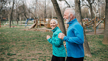 RV couple jogging outside to stay fit
