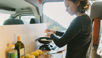a person in their rv making a meal to stay fit