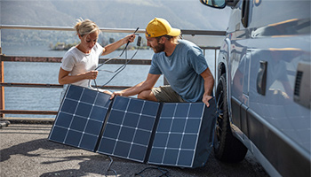 A couple setting up their portable rv solar panels