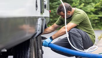 a person draining their RV's waste tank