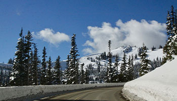 a road leading up to a snowy mountain