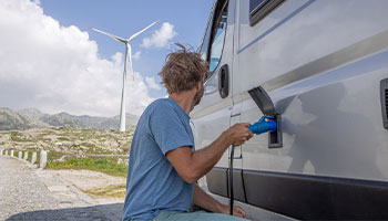 a person hooking up their camper to a power source