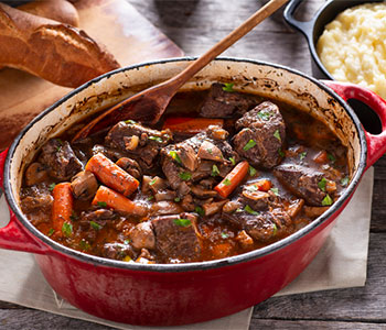 beef stew inside of a dutch oven 
