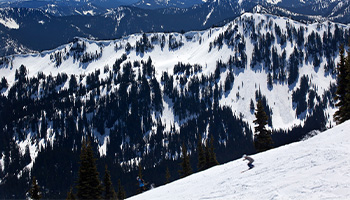 A person skiing down the slop at Crystal Mountain Resort