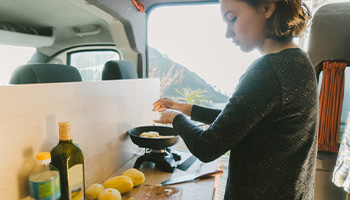a person saving money RVing by cooking their own meals