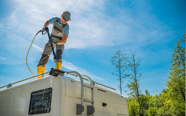 a person washing an RV after dewinterizing