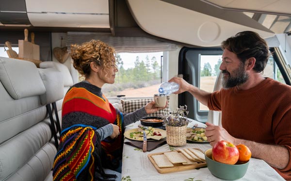 two people enjoying a meal together in their RV