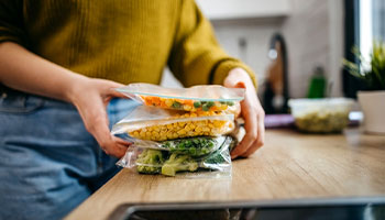 a person prepping for boondock cooking by prepping veggies at home