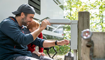 rv repairs - dad and son checking surge protector