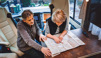 couple planning which RV show to go to on the map